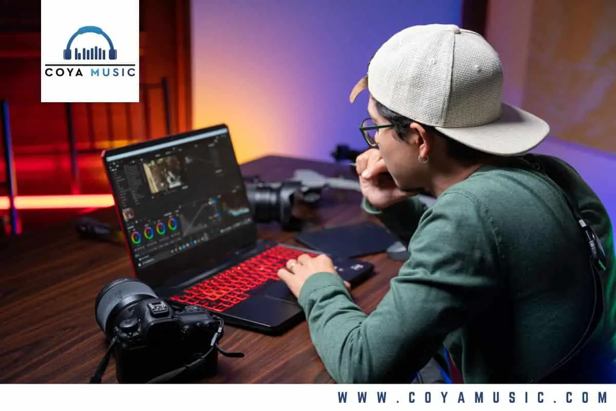 a video editor sits at a laptop working on a montage scene